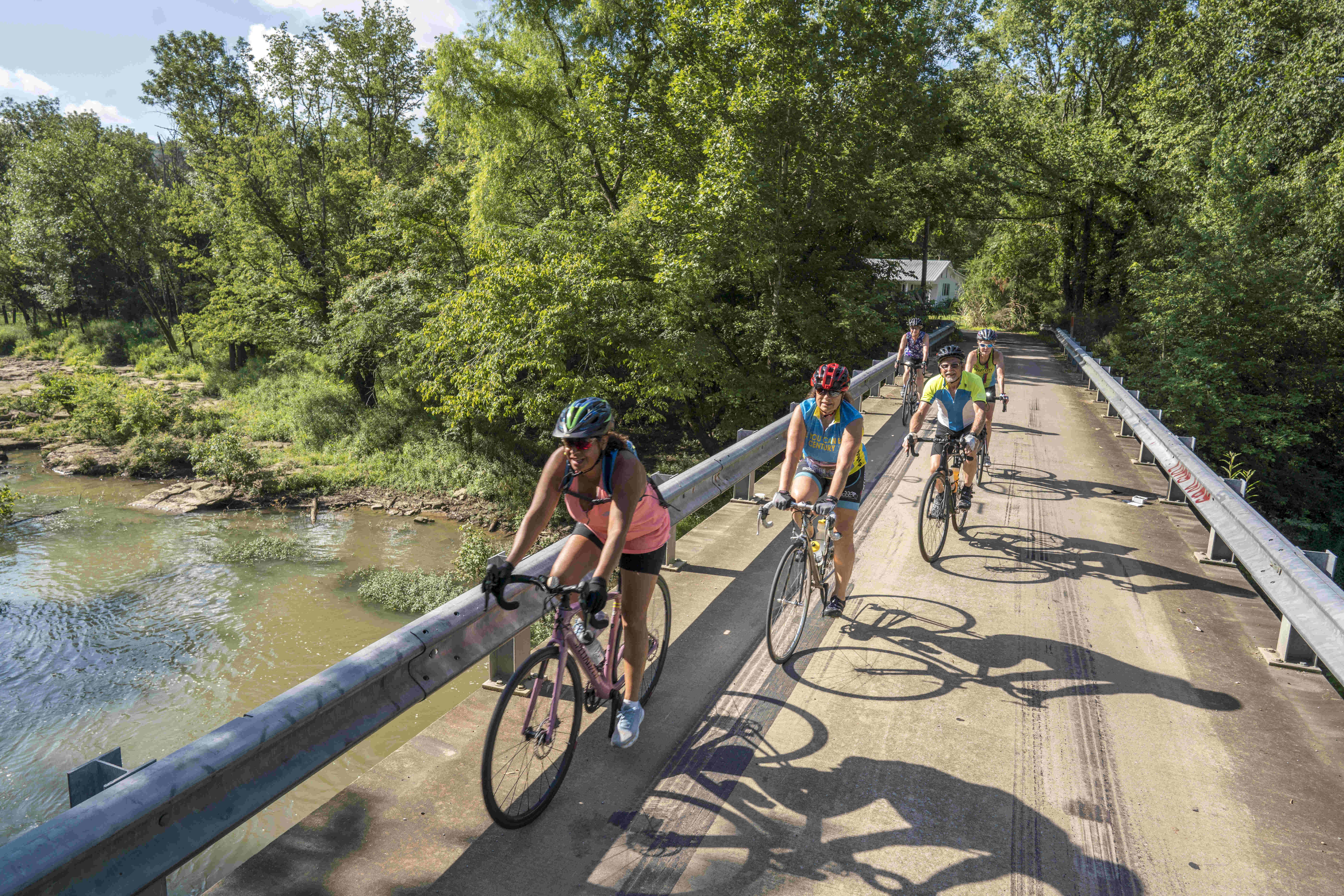 Bikers ride along path above waterway in Grant, Alabama.